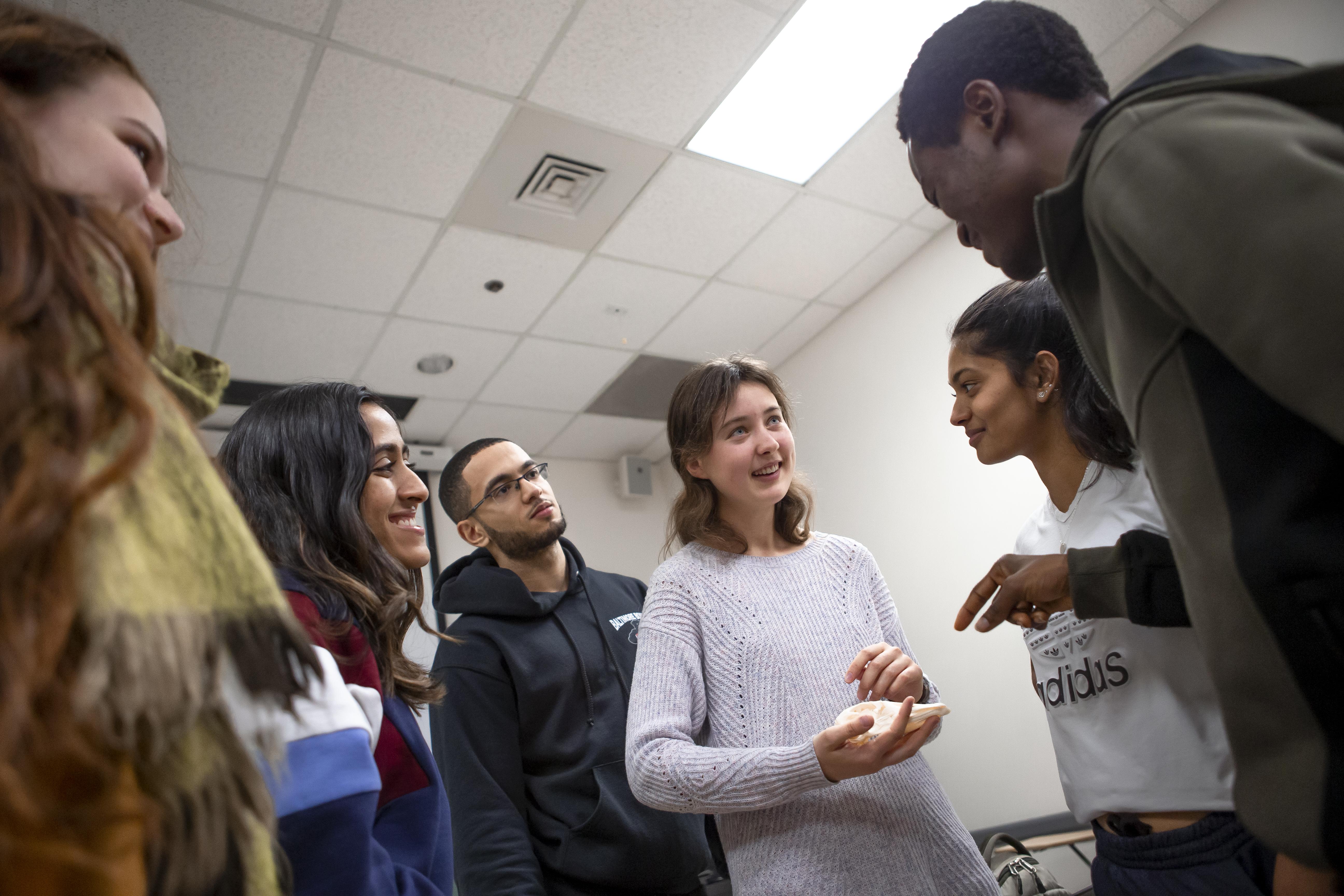 group of students (male and female) huddle together