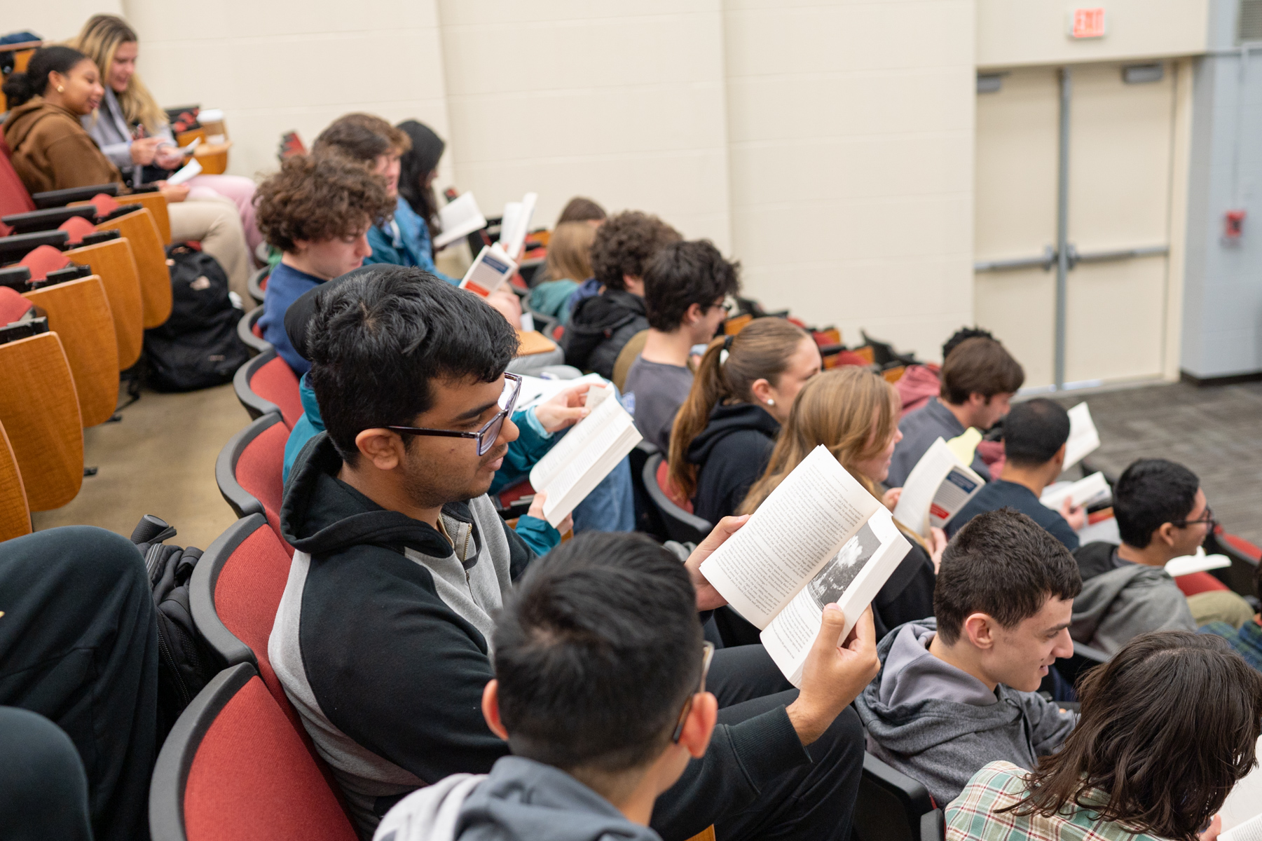 students in lecture hall with with open books