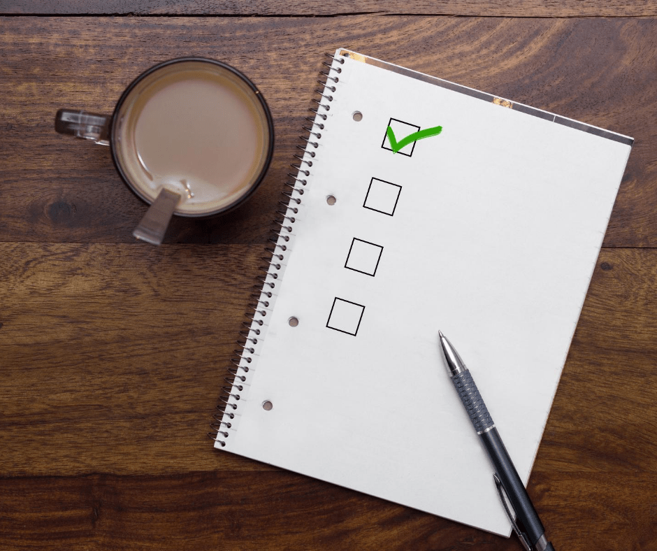 checklist on notepaper, coffee mug