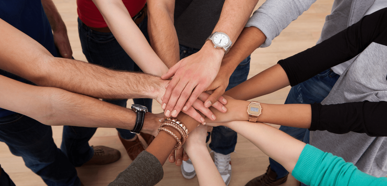 group of people with hands in circle