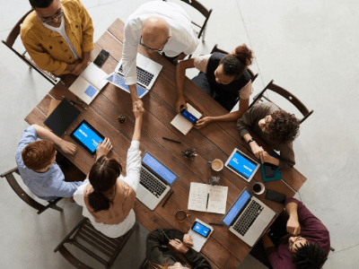 aerial shot of group of people meeting at conference table. all ages and ethnicity.